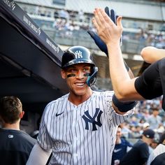 a baseball player holding his hands up in the air