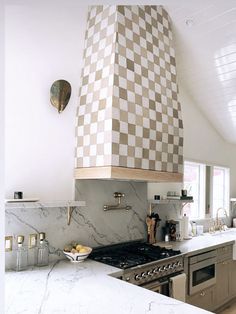 a stove top oven sitting inside of a kitchen next to an oven and countertop