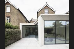 a house with large glass windows on the outside