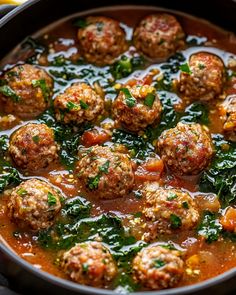 meatballs and spinach are in a red sauce