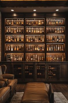 a living room filled with furniture and lots of bottles on the wall above it's shelves