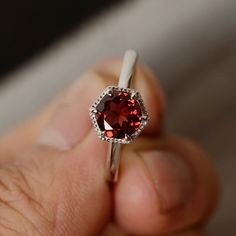 This is a gorgeous handmade creation. Its beauty is its simplicity & Elegance. The 7mm round cut natural garnet is crafted in solid sterling silver and with rhodium plated. All item is sent in a beautiful gift box You can realize more lovely stuff clicking the link https://www.etsy.com/shop/knightjewelry?refshopsection_shophome_leftnav Please leave the correct address and you phone number for delivering successfully. Garnet Birthstone Ring With Prong Setting In Fine Jewelry, Fine Jewelry Garnet Solitaire Ring, Fine Jewelry Garnet Birthstone Ring, Garnet Birthstone Ring For Promise, Round Cut, Classic Garnet Round Band Rings, Garnet Center Stone Birthstone Ring, Garnet Birthstone Ring With Round Cut For Promise, Garnet Birthstone Ring For Promise, Classic Garnet Ring With Round Band