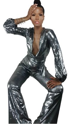 Dass jumpsuit by Nik Spruill takes glow up to the max! Form fitting silver stretch polyester material V neckline Full length bootcut hem Wrap front with belt included Back zipper Metallic Jumpsuit, Metallic Jumpsuits, V Neckline, Polyester Material, Metallic Silver, Leather Pants, Full Length, Leather Jacket, Turtle Neck