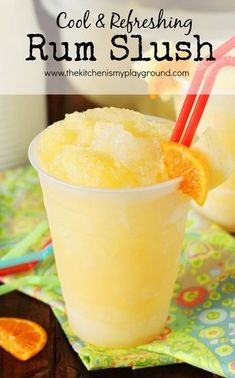 two glasses filled with orange slush sitting on top of a table