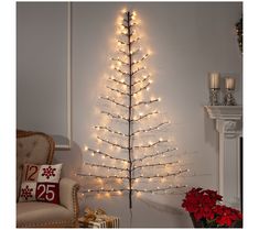 a white christmas tree with lights on it