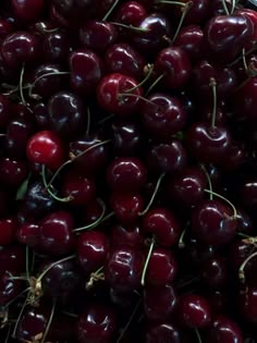 a pile of cherries sitting next to each other