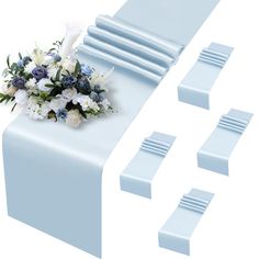 a bunch of blue and white flowers on top of a table