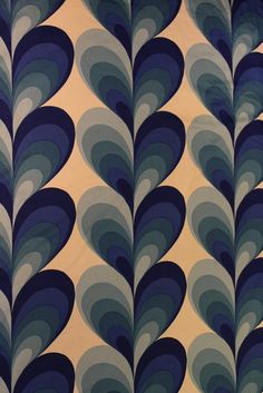 an abstract blue and white wallpaper with wavy shapes on it's side,