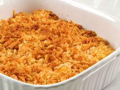 a white casserole dish filled with macaroni and cheese