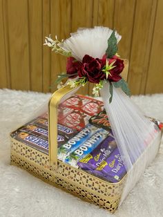 a gift bag filled with candy and flowers