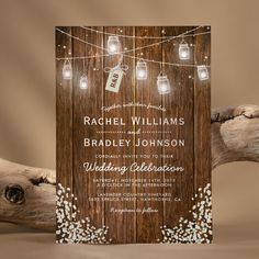 a wooden wedding card with mason jars and string lights