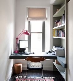 a room with a desk, chair and bookshelf next to a large window