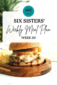 a hamburger sitting on top of a wooden cutting board next to potato chips and a sign that says six sisters'weekly meal plan week 30