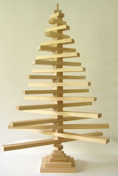 a wooden christmas tree made out of strips of wood