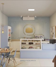 the interior of a pastry shop with blue chairs and counter top displays pastries on shelves