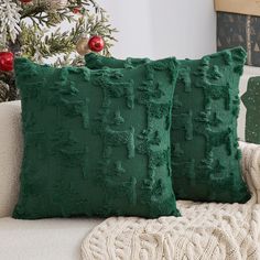 two green pillows sitting on top of a couch