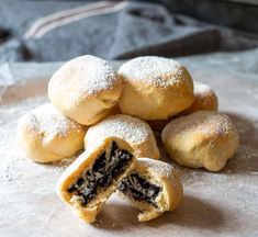 powdered sugar filled pastries with one cut in half