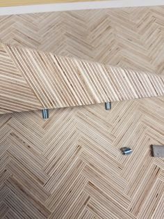 a close up of a wooden floor with screws