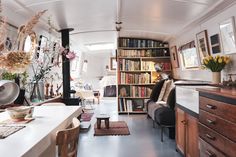 a living room filled with furniture and lots of books