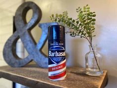 a bottle of deodorant sitting on top of a wooden shelf