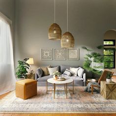 a living room filled with lots of furniture next to a wall mounted plant on top of a hard wood floor