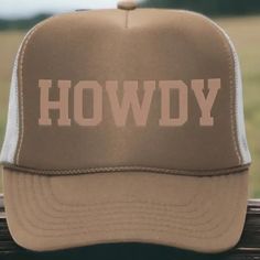 Get ready to tip your hat with our 'Howdy' Trucker Hat, perfect for both men and women! This stylish accessory comes in a classic tan and brown color scheme, featuring eye-catching, puff embossed text that adds a unique touch. Designed as an adult hat, it boasts a traditional 5-panel structure with breathable mesh sides and back for added comfort. Plus, its snapback design ensures a perfect fit for any head size. A blend of casual style and comfort, this trucker hat is ideal for everyday wear!- Brown Color Scheme, Embossed Text, Mens Trucker Hat, Brown Color Schemes, Custom Trucker Hats, Hat For Men, Hat For Man, Snapback Hat, Trucker Hats