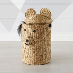 a basket with a bear face on the top and ears sticking out from it's sides