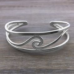 This handcrafted sterling silver wave cuff bracelet makes a beautiful statement on the wrist, with it's larger design. It is has more silver and is heavier than our other wave cuff.  Pairs perfectly with our Curling Wave Ring This bracelet is fairly adjustable as it is a cuff; it is offered in two different sizes:  S/M Adjustable Cuff Bracelet With Polished Finish, Elegant Adjustable Wavy Bracelets, Modern Wavy Silver Jewelry, Elegant Adjustable Wavy Bangle, Adjustable Wavy Sterling Silver Jewelry, Adjustable Silver Bangle With A Modern Twist, The Deep Ocean, Jewelry Hacks, Accessorize Jewellery