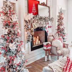 a living room decorated for christmas with red, white and silver decorations on the tree