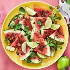 a yellow plate topped with watermelon slices and minty garnishes