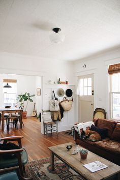 a living room filled with furniture and lots of windows