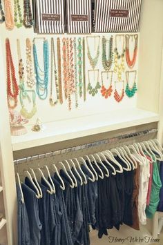 a closet filled with lots of different colored necklaces