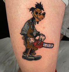 a cartoon dog with a chainsaw tattoo on his leg