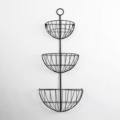 three tiered metal basket on the wall