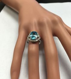 7.80 Carats Natural Very Nice Looking Blue Zircon and Diamond 14K Solid White Gold Ring Suggested Replacement Value: $6,500.00 Total Natural Oval Cut Blue Zircon Weight is: 7.00 Carats Natural Round Diamonds Weight: .80 Carats (color G-H / Clarity SI1-SI2) Ring total weight: 6.1 grams Disclaimer: all weights, measurements and colors are approximate and may vary slightly from the listed dimensions or as seen in the image. All pictures are magnified to show the smallest of details. Please, refer t Blue Topaz Ring In 14k White Gold, Formal Blue Brilliant Cut Gemstones, Blue Brilliant Cut Gemstones For Formal Occasions, Formal Aquamarine Diamond Ring With Brilliant Cut, Aquamarine Brilliant Cut Diamond Ring For Formal Occasions, Turquoise Sapphire Gemstone Ring For Anniversary, Blue Cubic Zirconia Rings With Diamond Accents, Blue Aquamarine Jewelry With Center Stone, Luxury Blue Brilliant Cut Gemstones