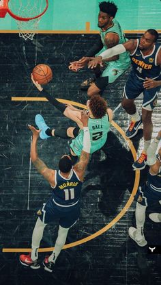 basketball players in action on the court during a game