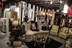 a room filled with lots of furniture and decor on top of carpeted flooring