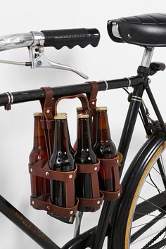 a bicycle with beer bottles attached to the handlebars is shown in this image