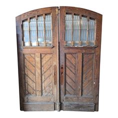 an old wooden double door with glass panels