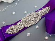 "Purple Wedding Dress Belt, Wedding Belt, Rhinestone Belt, Wedding Gown, Purple Bridal Sash, Bridesmaid Wedding Pearl Crystal Wide Sash Made with love in our studio in California <3 This gorgeous wedding belt will be an amazing complement  for your dress! The ribbon is double side faced silky satin or organza ribbon of high textile quality. It is pleasant to eye and soft to touch. The color is wholesome and saturated. The jewel part includes rhinestones, crystals, pearls of different sizes. The Belt Ribbon, Gown Purple, Jeweled Belts, Purple Wedding Dress, Purple Belt, Plus Size Wedding Gowns, Wedding Belt, Wedding Dress Belt, Wedding Sash Belt