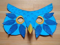 a blue bird mask sitting on top of a wooden table