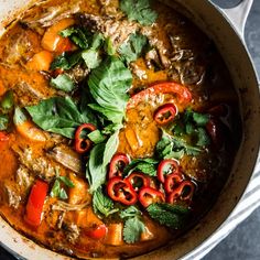 a pot filled with meat and vegetables on top of a table