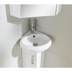 a white sink sitting under a bathroom mirror next to a wall mounted faucet