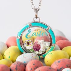 a necklace with an easter scene in the center surrounded by eggs