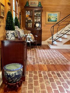 a living room with wood paneled walls and flooring