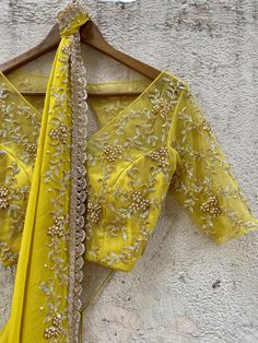 A two-piece mustard saree set from the Priti Sahni collection. This gorgeous mustard georgette pre-stitched ruffled saree with pearl and zardozi rose gold hand embroidery and scalloped edging is paired with a mustard net embroidered tie up blouse. Anarkali Blouse With Gota Work For Eid, Gold Dola Silk Blouse With Dupatta, Fitted Yellow Pre-draped Saree With Pallu, Elegant Yellow Silk Sharara, Yellow Chanderi Saree For Reception, Yellow Georgette Pre-draped Saree With Pallu, Designer Pre-draped Yellow Saree, Yellow Designer Wear Pre-draped Saree, Yellow Pre-draped Designer Saree