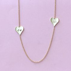 Add a romantic touch to your layered necklaces with this dainty necklace made of 14k gold. Two hearts engraved with your loved ones names makes a perfect and personal gift. This fine necklace is easy to wear with everything, fits perfectly with other necklaces, and also looks fabulous on it's own. This is a must-have necklace. All features can be customized! Talk to us, we love making custom designs. Our jewelry is carefully handmade in our atelier Our diamonds are conflict free To order by phone click here>> +972(0)722991000 Elegant Customizable Heart Necklace For Anniversary, Engraved Double Heart Yellow Gold Necklace, Customizable Elegant Charm Necklace For Valentine's Day, 14k Gold Engraved Heart Name Necklace, 14k Gold Double Heart Engraved Necklaces, 14k Gold Double Heart Engraved Necklace, Elegant Double Heart Engraved Name Necklace, Personalized Yellow Gold Double Heart Necklace, Elegant Engraved Double Heart Name Necklace