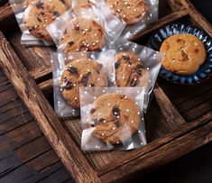 cookies and muffins are wrapped in plastic on a tray