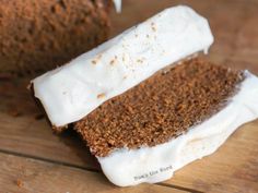 two pieces of cake sitting on top of a wooden table