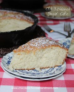 a piece of cake sitting on top of a blue and white plate next to a skillet